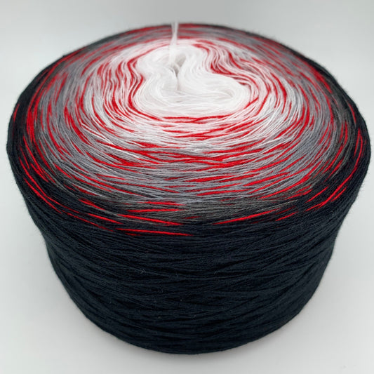 Farbverlauf Bobbel von innen nach aussen Weis, Grautöne und Schwarz. Ein roter Beilauffaden